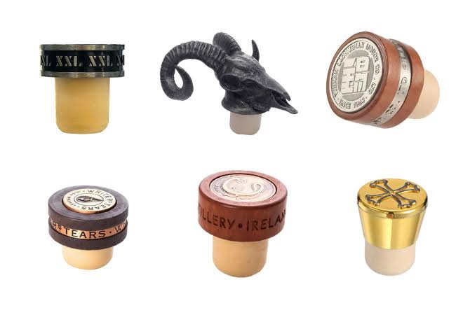 Compare bar-top stopper materials for spirits bottles, including cork, wood, plastic, aluminum, Zamak, fit testing, compliance, and RFQ tips.