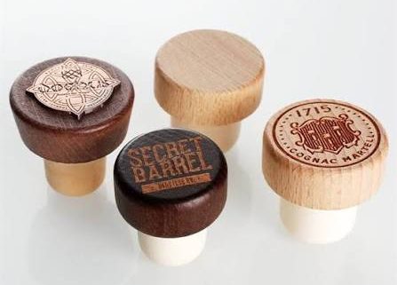 Compare wood, metal, plastic and glass bar-top stopper materials for spirits bottles. Review fit, decoration, compliance and request samples.